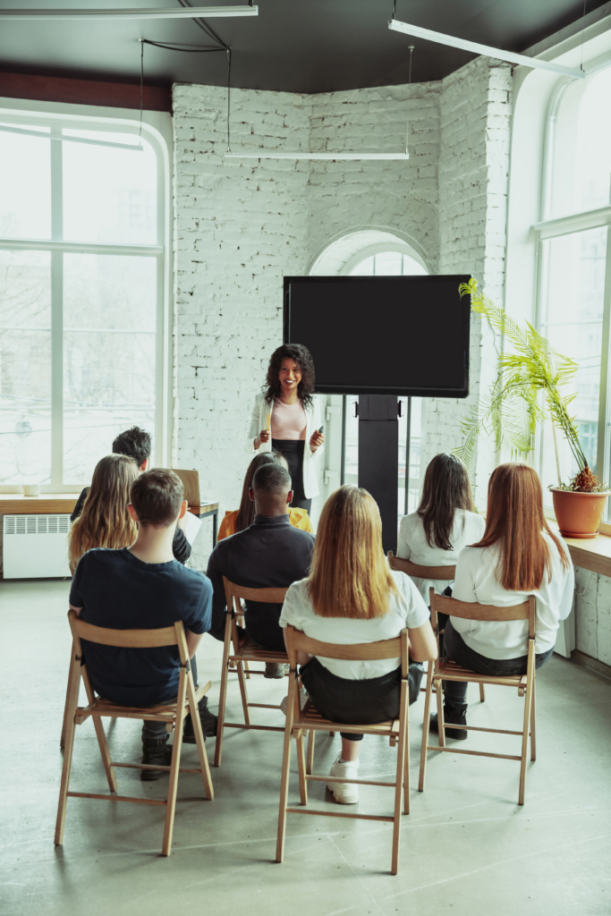 female african american speaker giving presentation hall university workshop