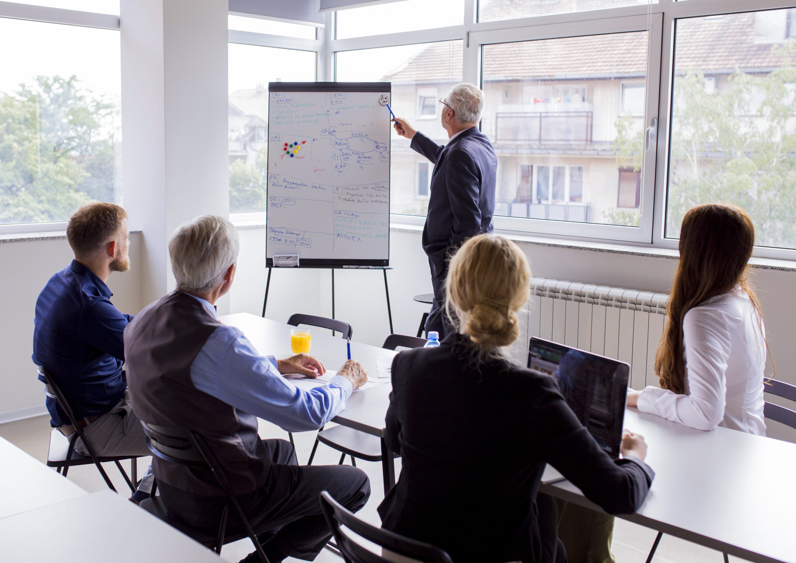 senior businessman giving presentation colleagues office senior businessman giving presentation colleagues office